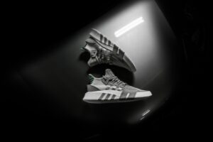 grayscale photo pair of adidas shoes